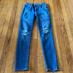 Medium wash Levi skinny jeans. Ripped.